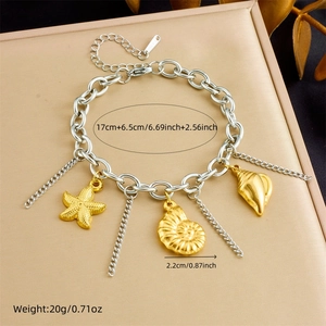 Detail view of gold starfish and shell charms on a chunky silver chain bracelet