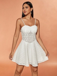 White eyelet lace A-line mini dress with spaghetti straps and waisted silhouette