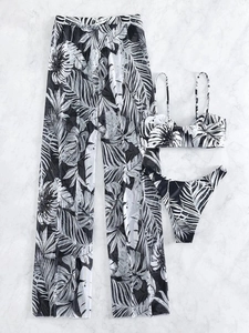 Flat lay of 3-piece bikini set with tropical leaf print and mesh beach pants