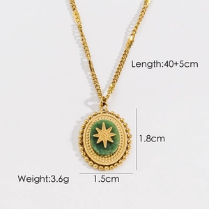 Macro shot of gold necklace with green oval stone pendant featuring star relief carving