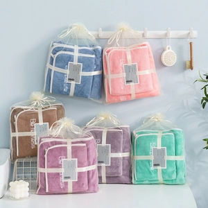 Detail of soft bear gift towels in five colors with ribbon and mesh bag packaging