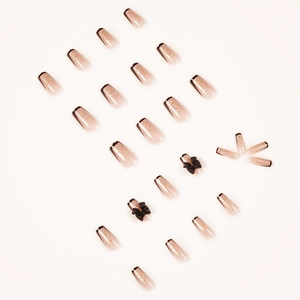 French tip press-on nails with black edges, gold glitter gradient and 3D bows