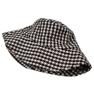 Close-up of black and white houndstooth tweed bucket hat with a thick wool texture