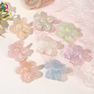 Macro detail of eight pearlescent floral hair claws in various soft pastel colors