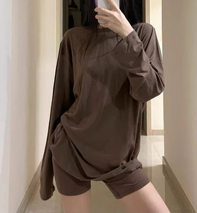 Close-up of dark brown long-sleeved T-shirt and tight shorts set in soft knit fabric