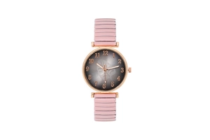 Detail of rose gold case with leaf pattern dial and pink elastic stretch band watch