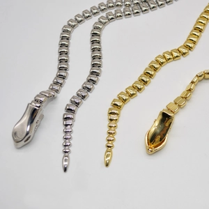 Close-up of punk snake-head metal chains in gold and silver finish for waist or neck