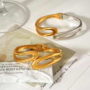 Polished stainless steel two-tone open bangle bracelet with modern wavy art design