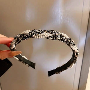 Elegant tweed headband with white faux pearls featuring a stylish twisted woven design