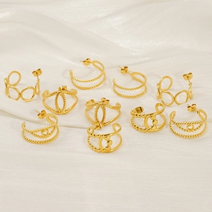 Detailed view of assorted gold hollow geometric earrings on a white silk background