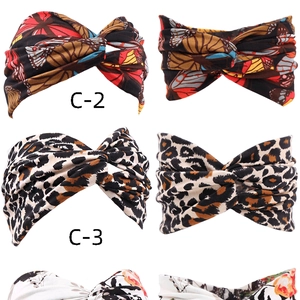Detail showing elastic headbands with leopard, butterfly, and floral patterns