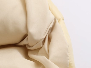 Close-up of beige hooded cotton jacket showing premium woven polyester fabric texture