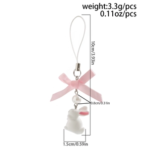 Detail shot of cute white bunny phone charm with pink ribbon and dimensions