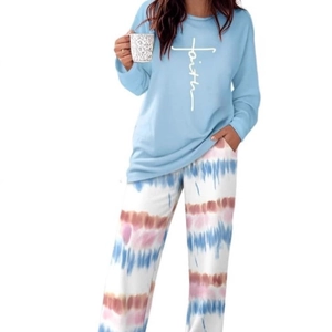 Women's pajama set featuring faith print blue top and colorful tie-dye knit pants