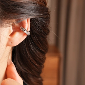 Detailed view of silver zircon ear cuff with double-layer snake-shaped geometric pattern