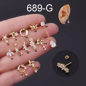 Detailed display of 12 gold flower and butterfly surgical steel earrings with cubic zirconia