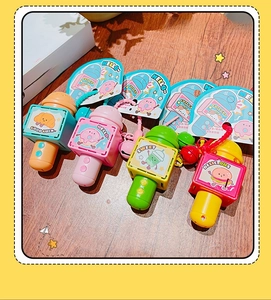 Macro shot of colorful cartoon food microphone keychains with matching bells and tags