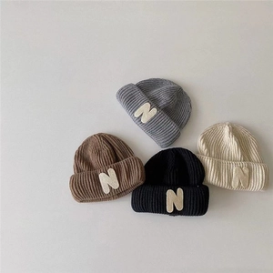 Kids knitted beanie hats with N patch in gray, brown, black, and beige colors