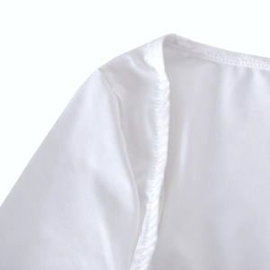 Detailed macro view of white fabric texture and precise stitching on the mini dress