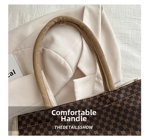 Detail of vintage monogram linen tote bag with sturdy woven rope handles and fine stitching