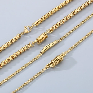 Detail of gold titanium steel chains showing spring clasp and polished cuban links