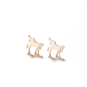 Detailed view of unicorn stud earrings in rose gold finish with reflection