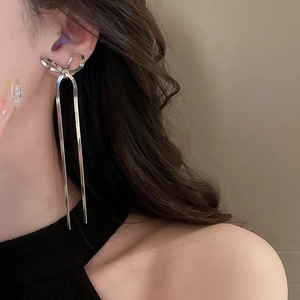 Silver bow tassel drop earrings shown on model for elegant long dangling visual effect