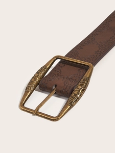 Close-up of brown embossed leather belt with vintage bronze carved metal buckle detail