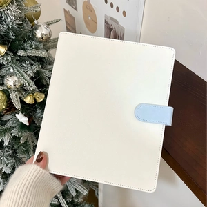 Close-up of a white glitter PU leather binder cover with a light blue magnetic buckle clasp
