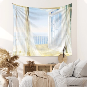 Detail of bohemian tapestry featuring a sea view balcony with airy white curtains