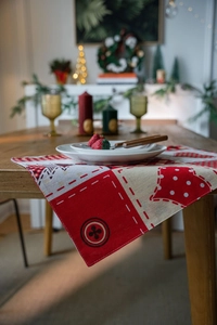 Detailed close-up of a festive patchwork Christmas table runner with heart and dot prints