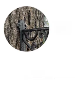 Close-up of vintage cast iron bracket showing secure screw mounting on rustic wood