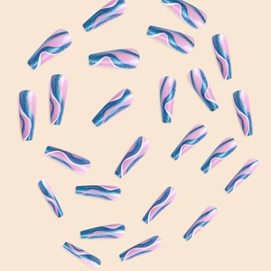 Macro view of long coffin false nails in pink with blue and silver glitter wave patterns