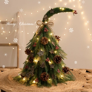 Mini DIY Christmas tree with LED lights and pine cones on a cozy burlap base