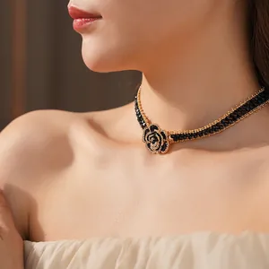 Luxurious double-strand black beaded choker with a crystal rose pendant on a model