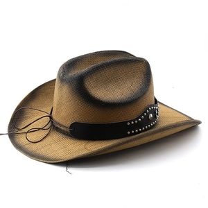 Detail of straw cowboy hat featuring black leather band with silver studs and blue beads
