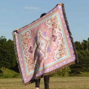 Detailed view of bohemian woven throw blanket featuring colorful patterns and fringe edges