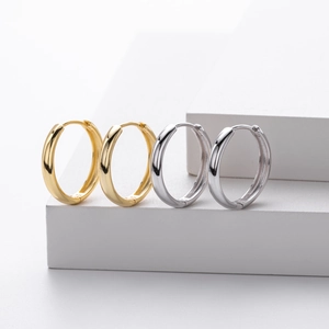 Macro view of gold and silver minimalist S925 sterling silver hollow hoop earrings
