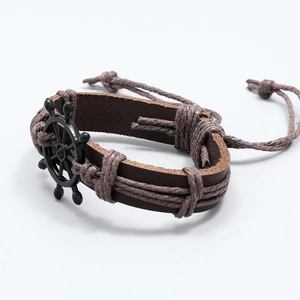 Nautical leather bracelet with a black metal helm charm and adjustable braided cord