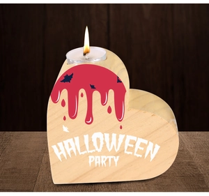 Detail of wooden heart candle holder with blood drips, bats and Halloween Party text