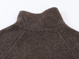 Gros plan détaillé du col d'un manteau en laine marron foncé à texture épaisse