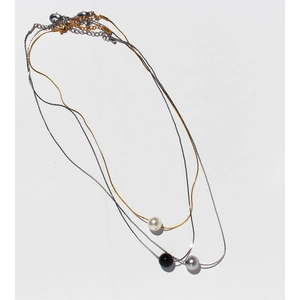 Three-piece necklace set with minimalist gold and silver chains and pearl pendants