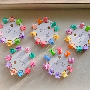 Detailed view of colorful mini flower hair clips in various macaron pastel shapes and colors