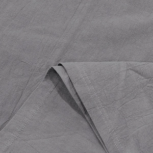 Detail of grey linen fabric with high-quality double-stitched seams and textured weave