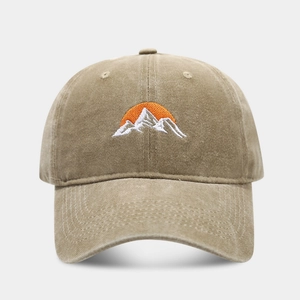 Close-up of khaki washed cotton baseball cap with embroidered mountain and sun pattern