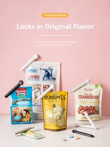 Cat paw shaped food clips for sealing snack bags on a pink and marble background
