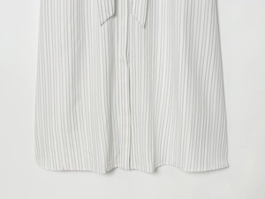 Detailed close-up of striped long sleeve dress with waist belt and fine stitching