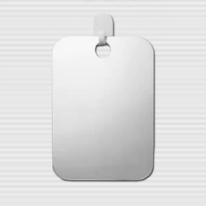 Macro detail of a blank silver rectangular metal tag with rounded corners and hanging hole