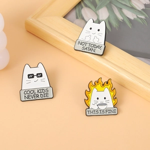 Three creative enamel cat brooches featuring humorous text and meme designs in metal pins