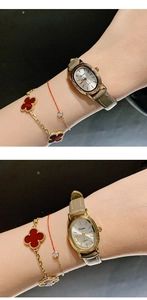 Close-up of Dunami gold oval watch with beige leather strap on model's wrist
